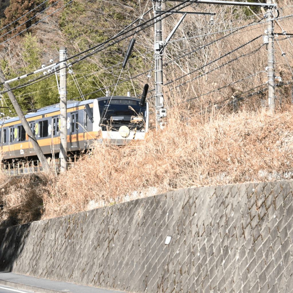 [画像：小屋から見えるJR電車]