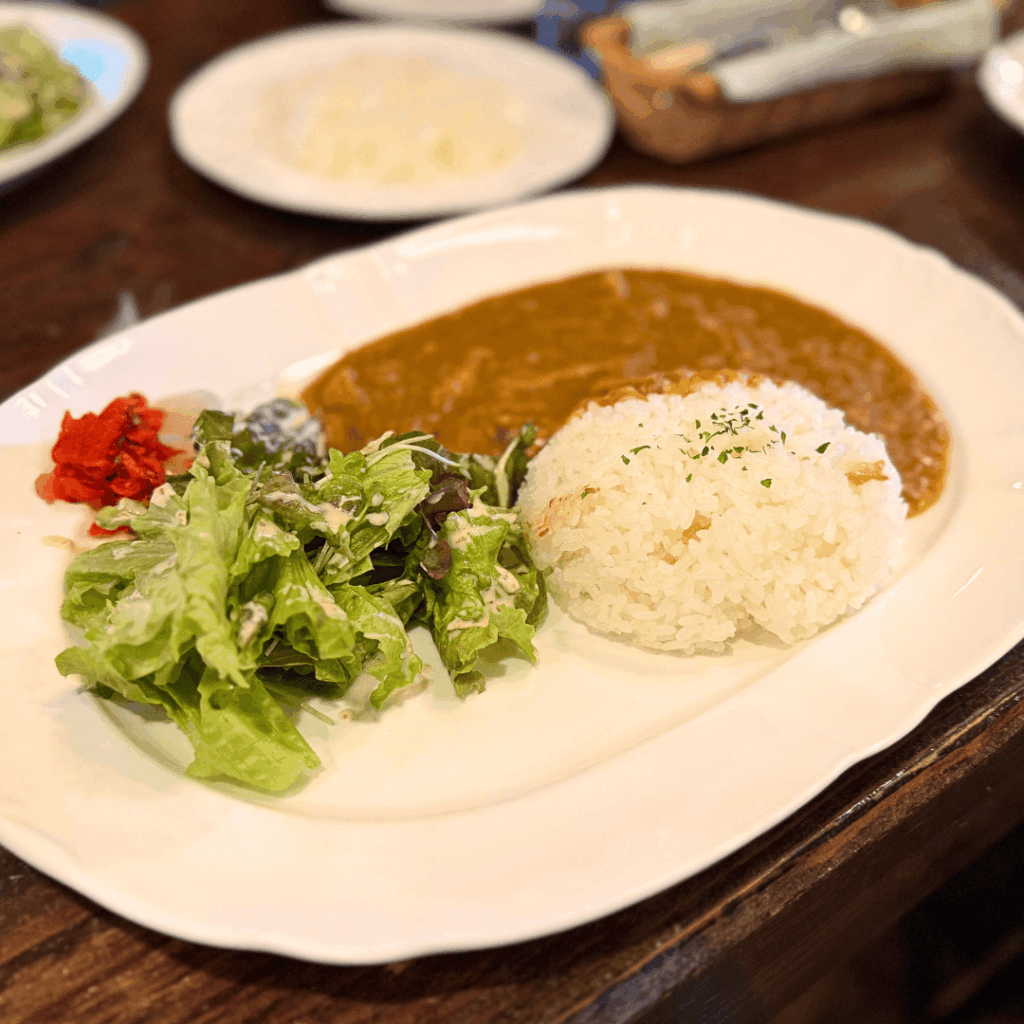 [画像：じっくり煮込まれた特製チキンカレー]